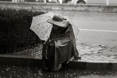 描写古代男人在雨中打伞